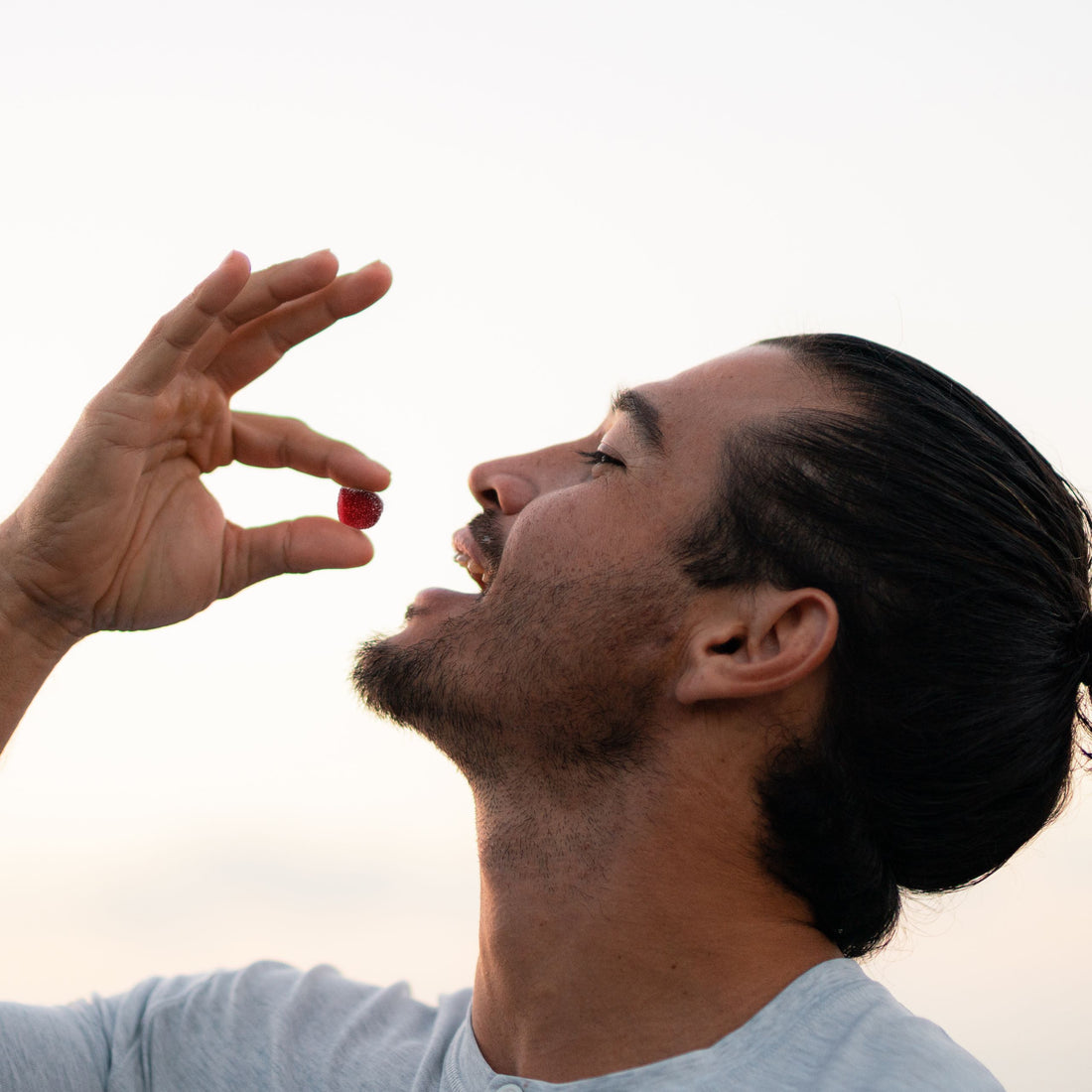 A person eating THC gummies