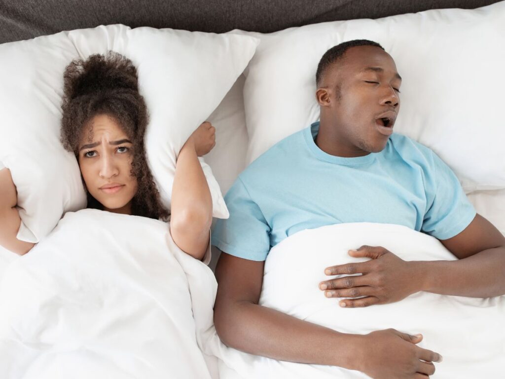 Mouth Taping and Sleep: What's The Connection? 3 A woman disturbed by the snores of her partner